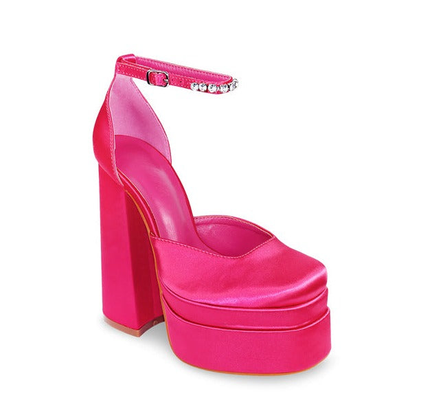 Hot Pink Chunky Platform Heel. Refresh your wardrobe, with these eye catching closed toe and a chunky platform heels. Rhinestone lined ankle strap detail with an chunky block heel to give style and comfort. Featuring colors are lavender, red and hot pink.  
