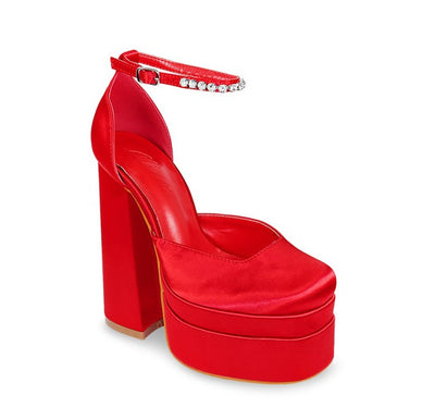 Red Chunky Platform Heel. Refresh your wardrobe, with these eye catching closed toe and a chunky platform heels. Rhinestone lined ankle strap detail with an chunky block heel to give style and comfort. Featuring colors are lavender, red and hot pink.  