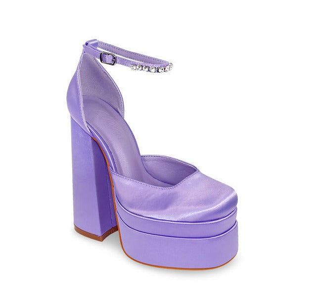 Purple Chunky Platform Heel. Refresh your wardrobe, with these eye catching closed toe and a chunky platform heels. Rhinestone lined ankle strap detail with an chunky block heel to give style and comfort. Featuring colors are lavender, red and hot pink.  
